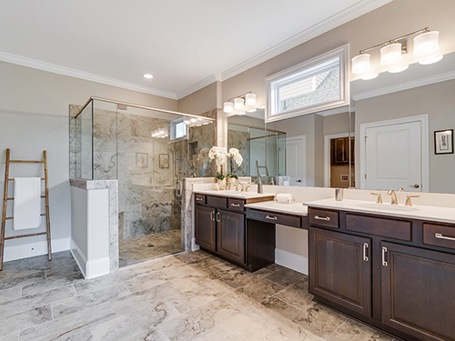 Universal design trends like raised vanities and walk-in showers with bench seating. >
